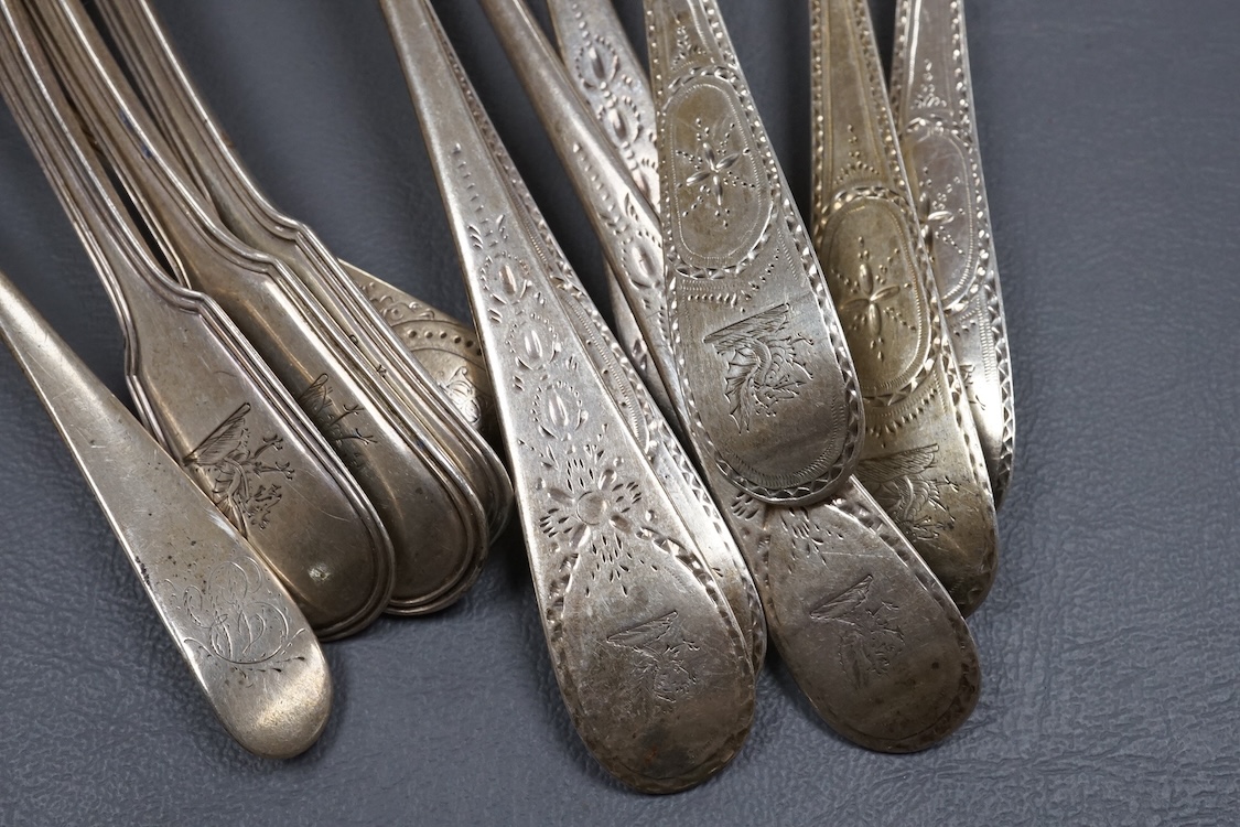 Seven assorted George III bright cut engraved silver Old English pattern table spoons, together with five other silver spoons, various dates and makers, 19.4oz.
